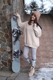 Young snowboarder wearing winter sport clothes outdoors