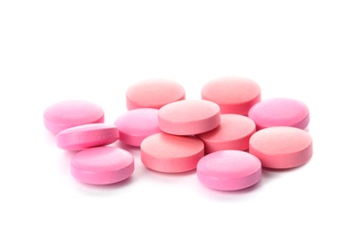 Photo of Color pills on white background. Medical care