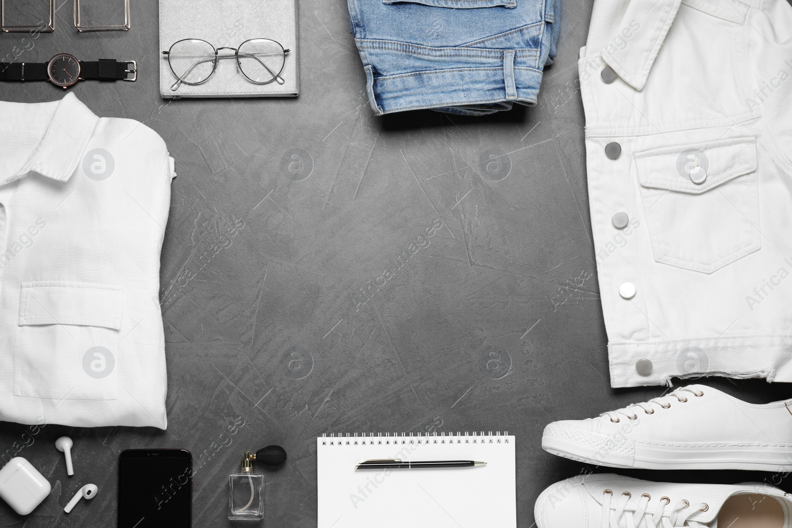 Photo of Stylish clothes and accessories on grey stone table, flat lay. Space for text