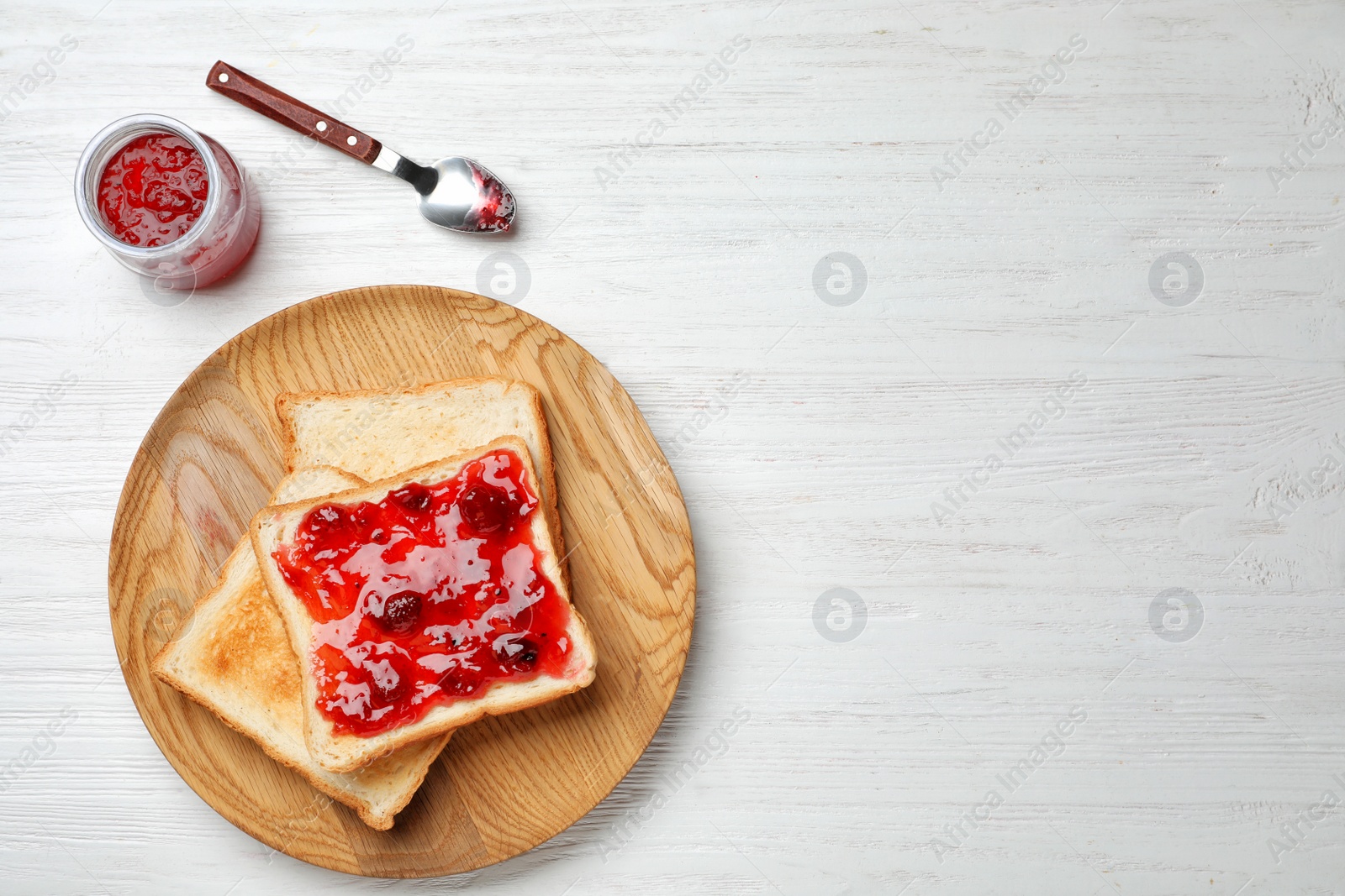 Photo of Toasts with jam on wooden background, top view