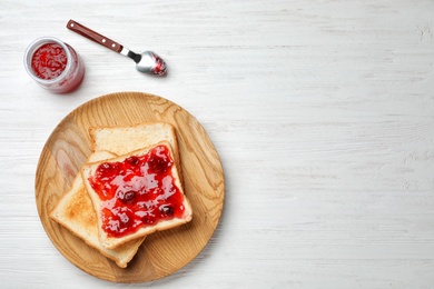 Photo of Toasts with jam on wooden background, top view