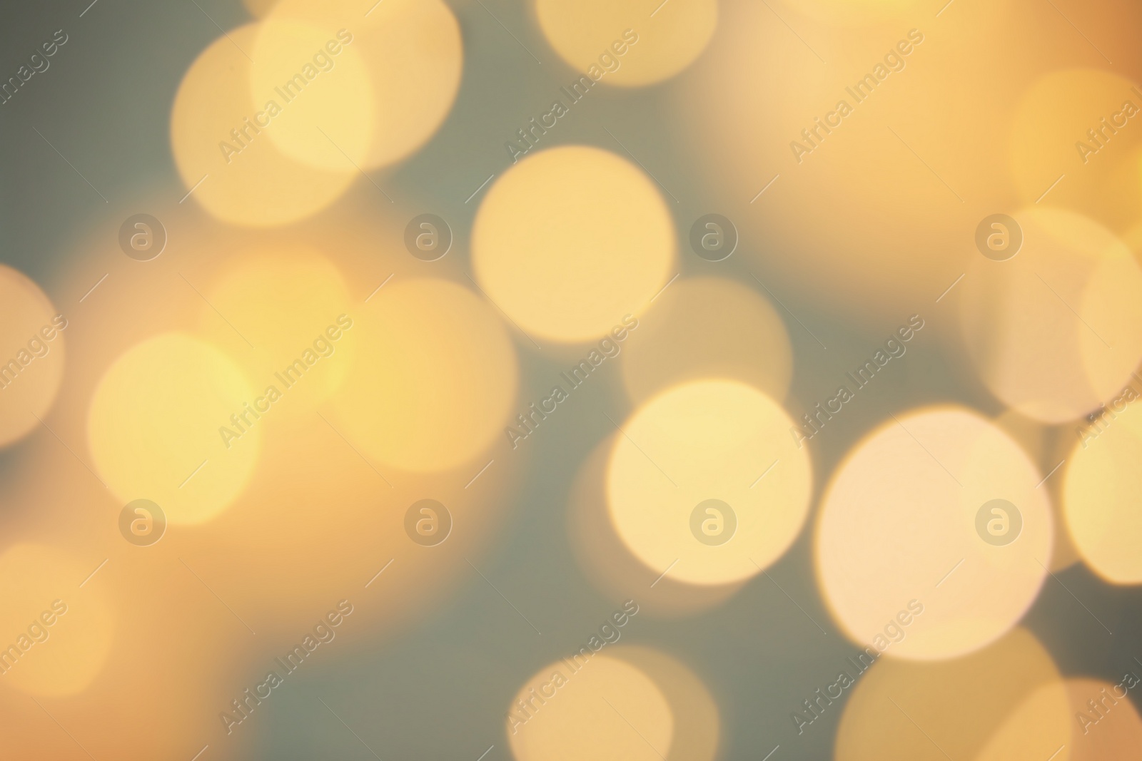 Photo of Blurred view of shiny gold lights. Bokeh effect