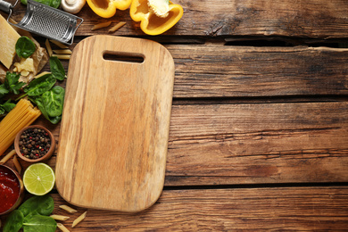 Flat lay composition with fresh products on wooden table, space for text. Healthy cooking