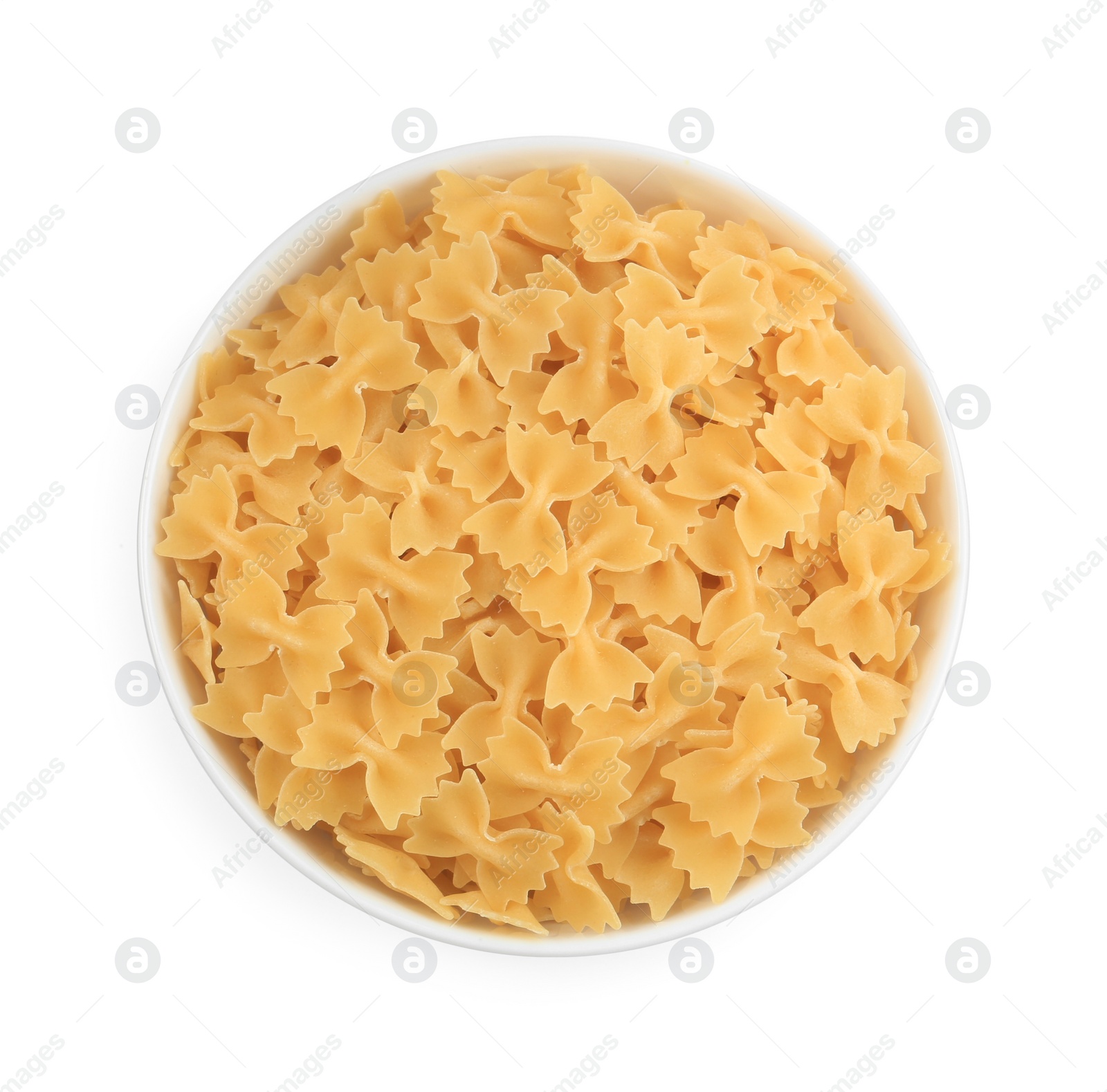 Photo of Raw farfalle pasta in bowl isolated on white, top view