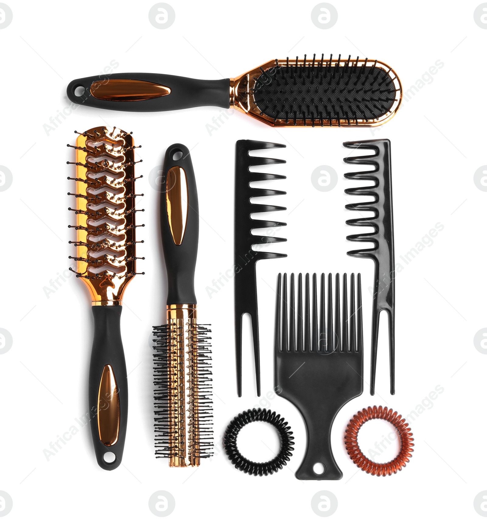 Photo of Set of modern hair combs and brushes and spiral rubber bands isolated on white, top view