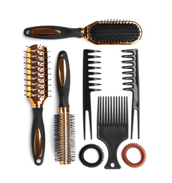 Photo of Set of modern hair combs and brushes and spiral rubber bands isolated on white, top view