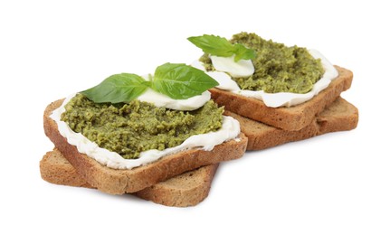 Tasty bruschettas with cream cheese, pesto sauce and fresh basil on white background