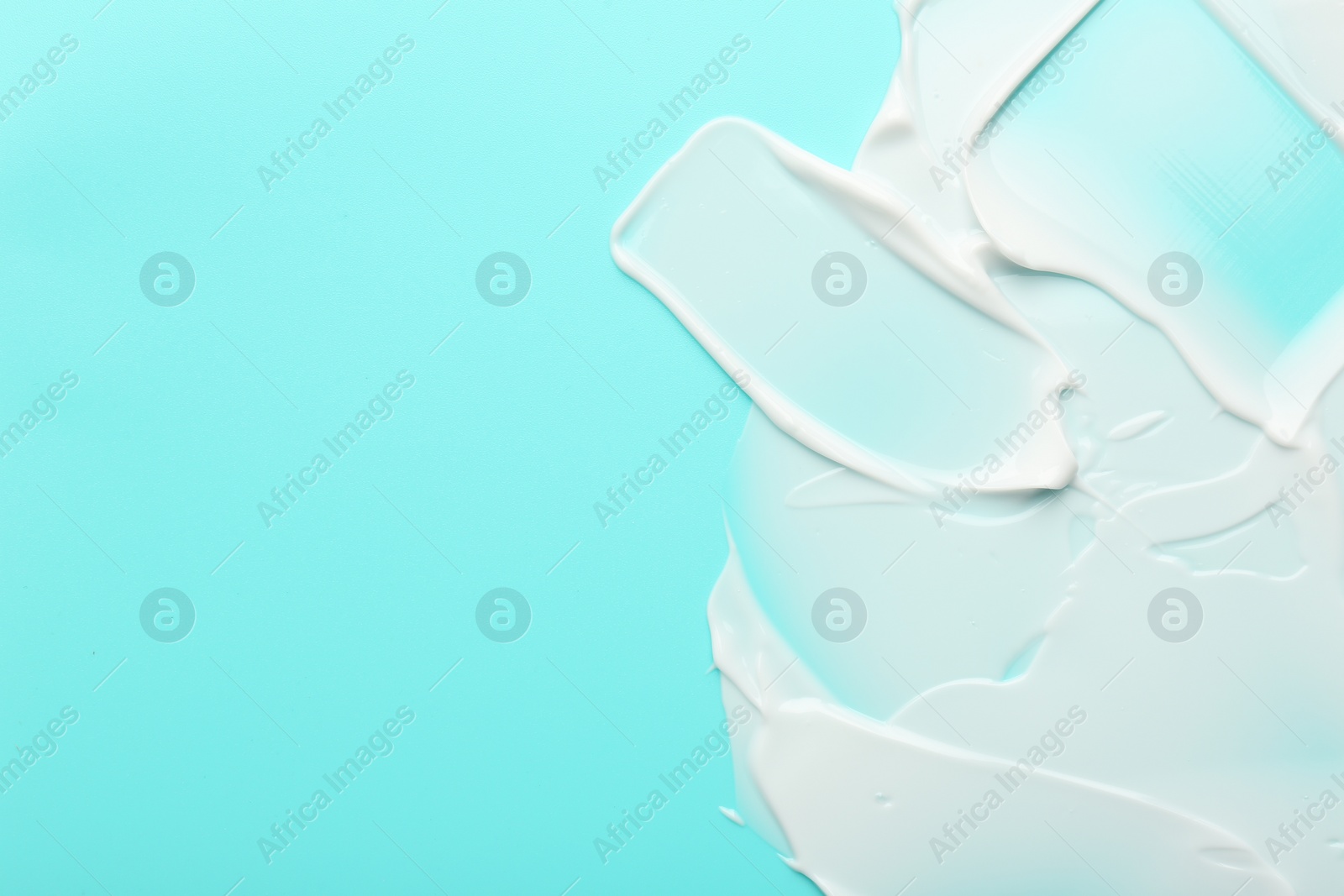 Photo of Face cream on light blue background, top view. Space for text