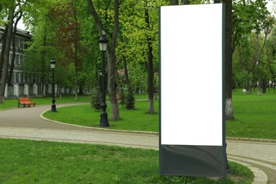 Photo of Blank advertising board in park. Space for design