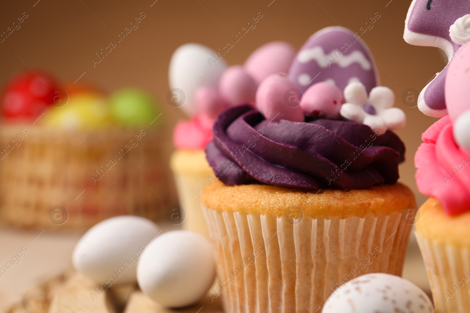 Photo of Tasty cupcake with Easter decor on table, closeup. Space for text