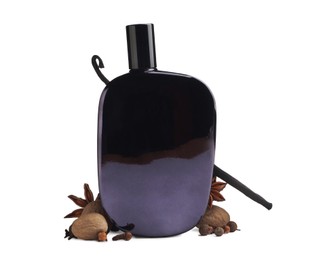 Bottle of perfume and different spices on white background