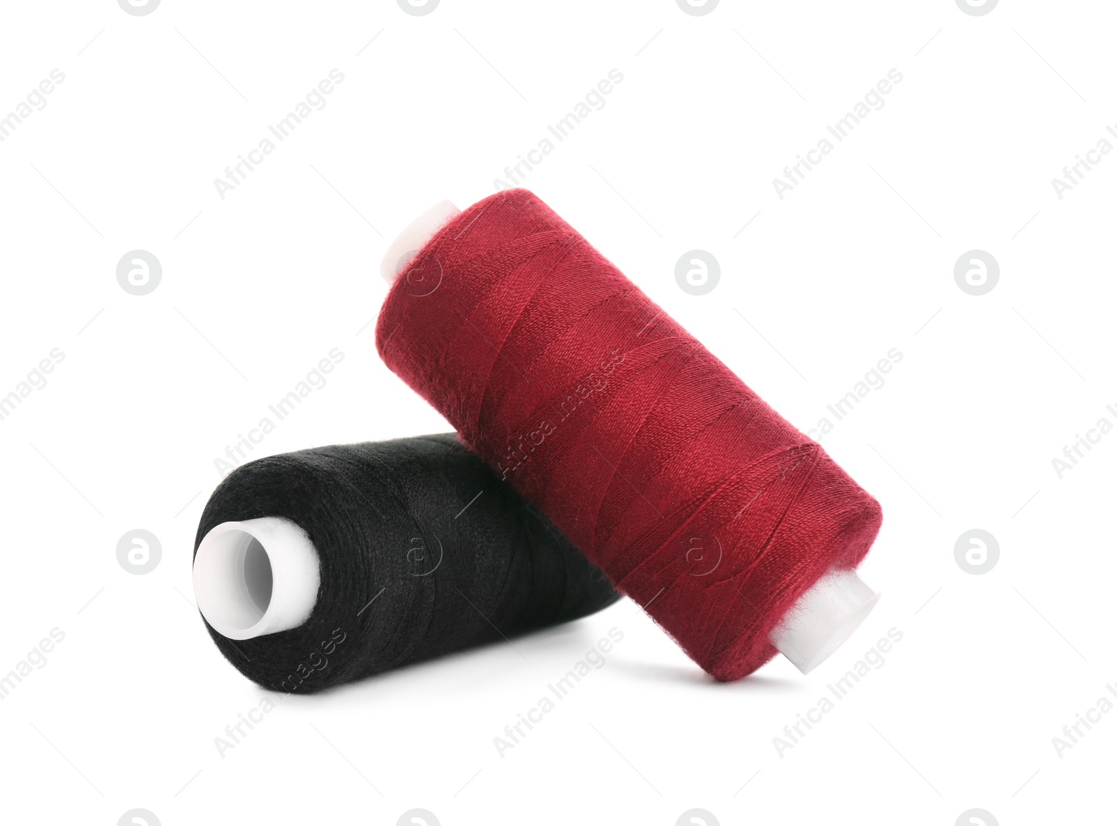 Photo of Different colorful sewing threads on white background