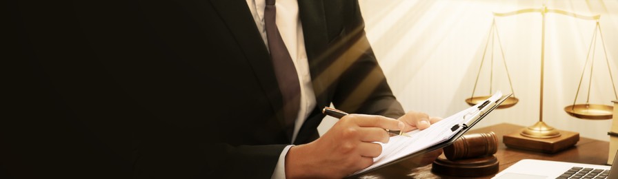 Image of Law and justice. Man working with documents at wooden table, closeup. Banner design