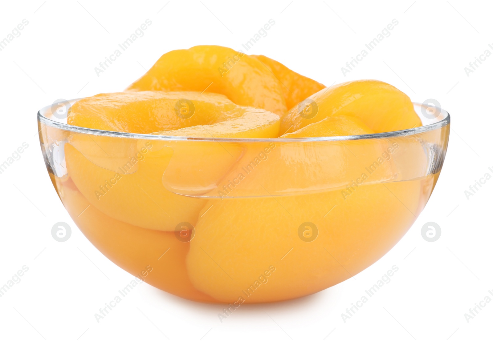 Photo of Halves of canned peaches in bowl isolated on white