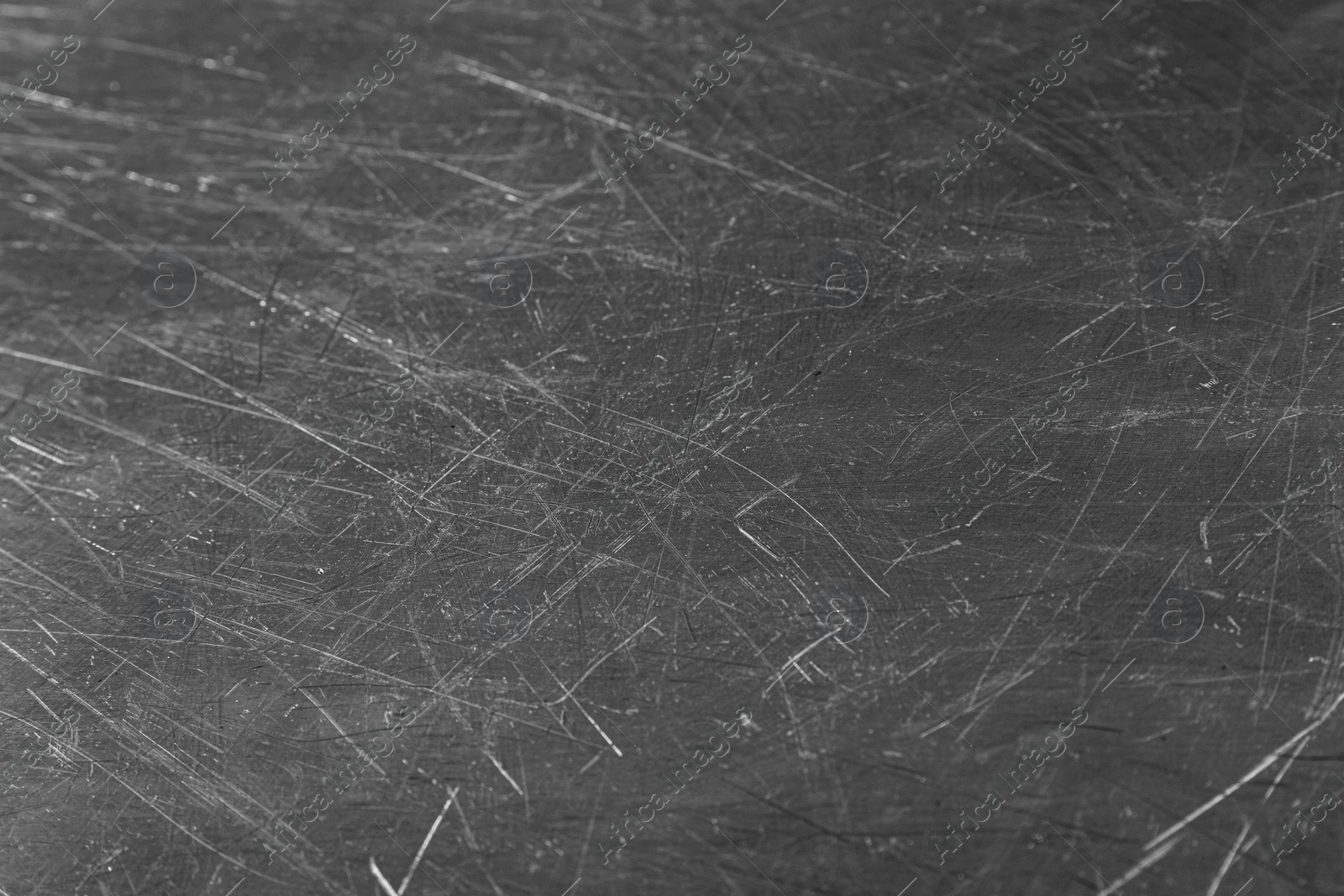 Photo of Texture of scratched metallic surface as background, closeup