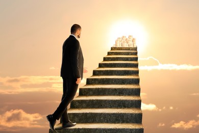 Image of Steps to success. Businessman climbing up stairs to reach wealth. Stairway in sky leading to sun