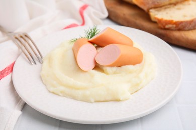 Photo of Delicious boiled sausages and mashed potato on white table, closeup