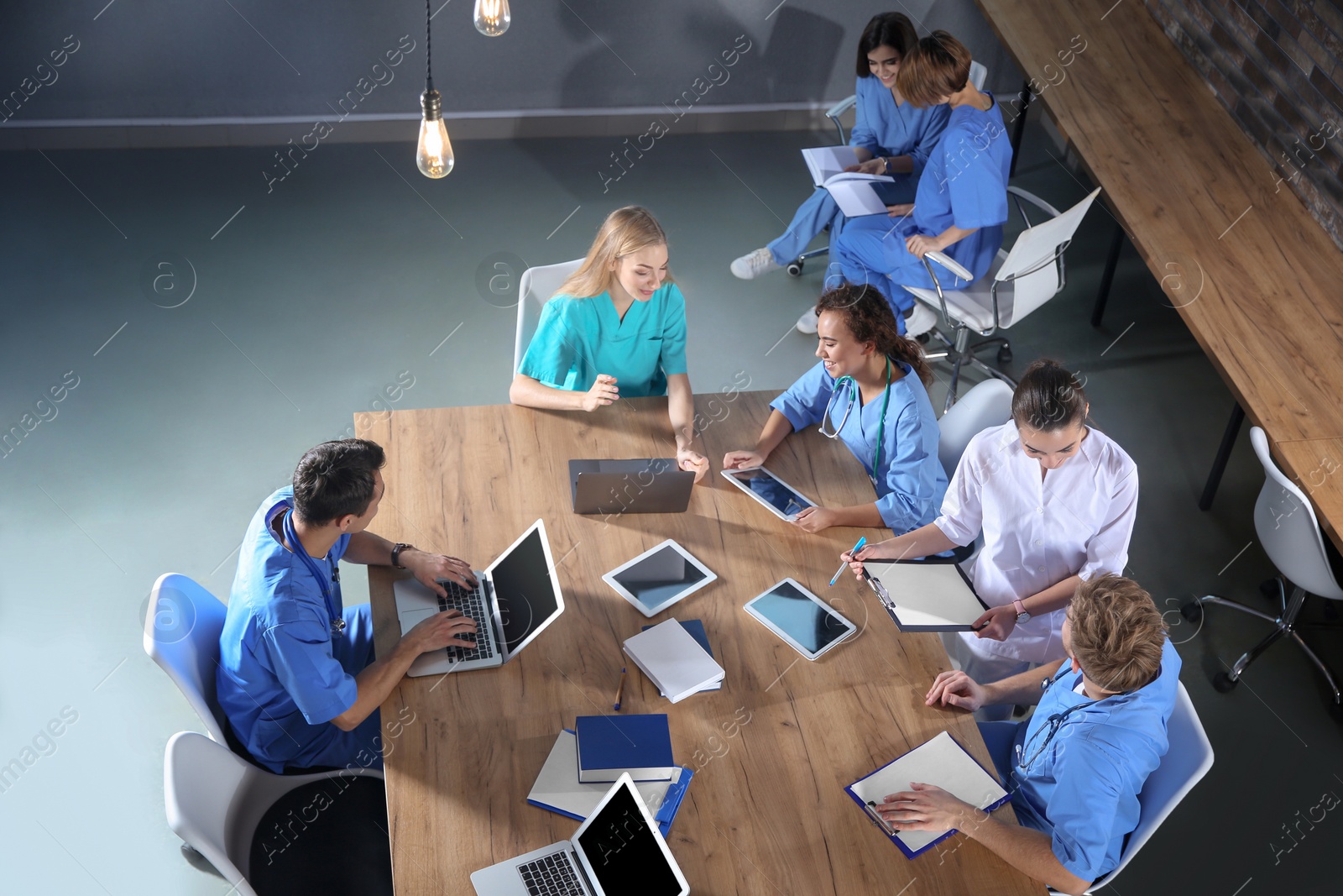 Photo of Group of medical students with gadgets in college, top view