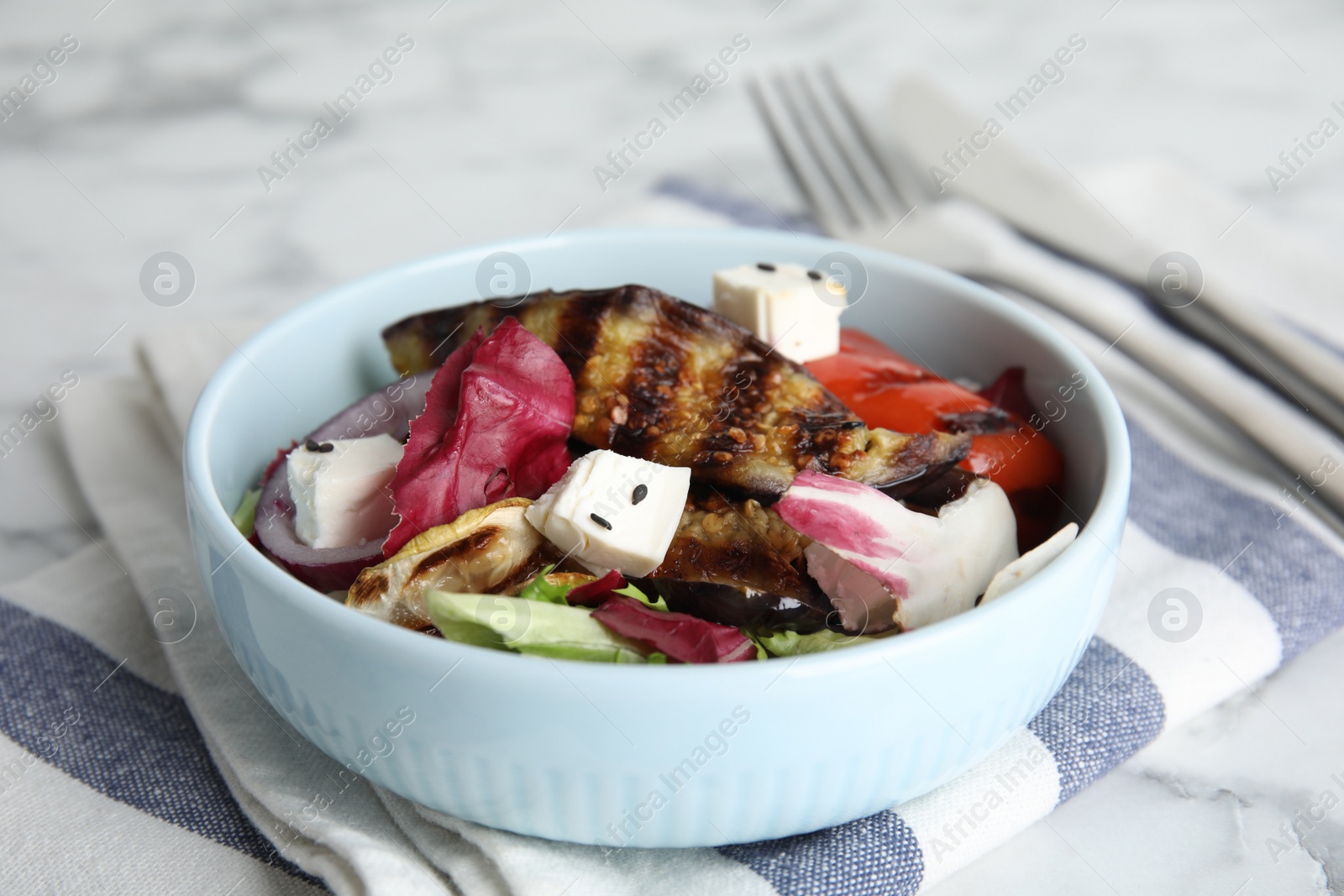 Photo of Delicious salad with roasted eggplant, feta cheese and chia seeds served on table