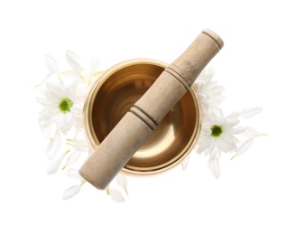 Photo of Golden singing bowl with mallet and flowers on white background, top view. Sound healing