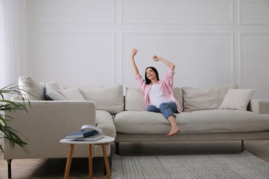 Photo of Woman resting on sofa in living room