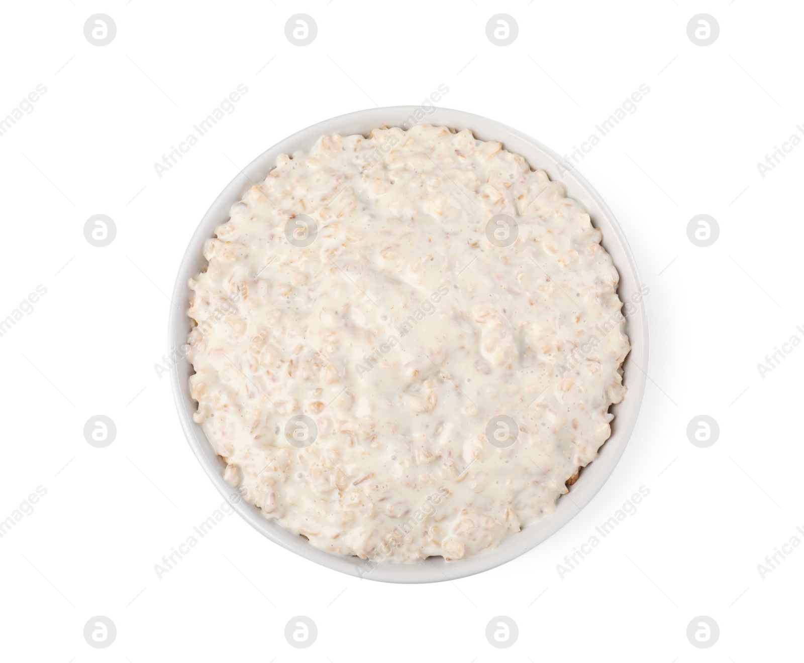 Photo of Tasty boiled oatmeal in bowl isolated on white, top view