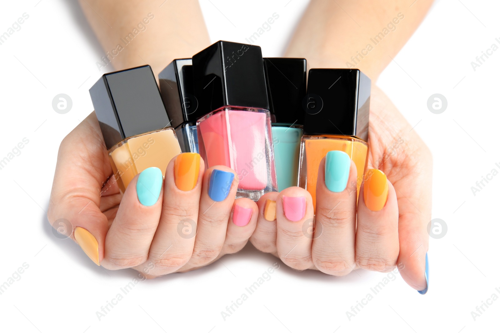 Photo of Woman holding bottles of nail polish on white background, closeup