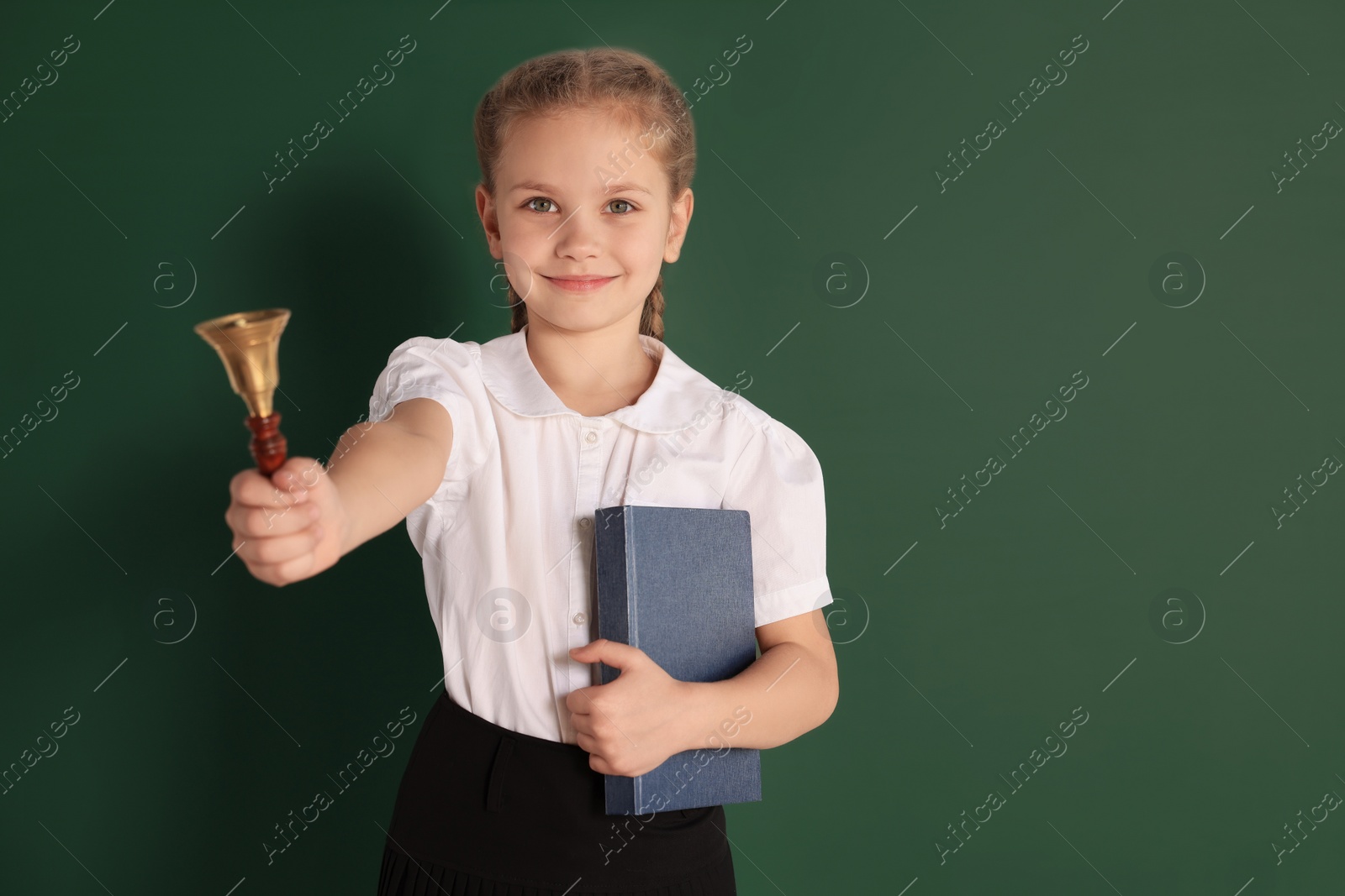 Photo of Pupil with school bell near chalkboard, space for text