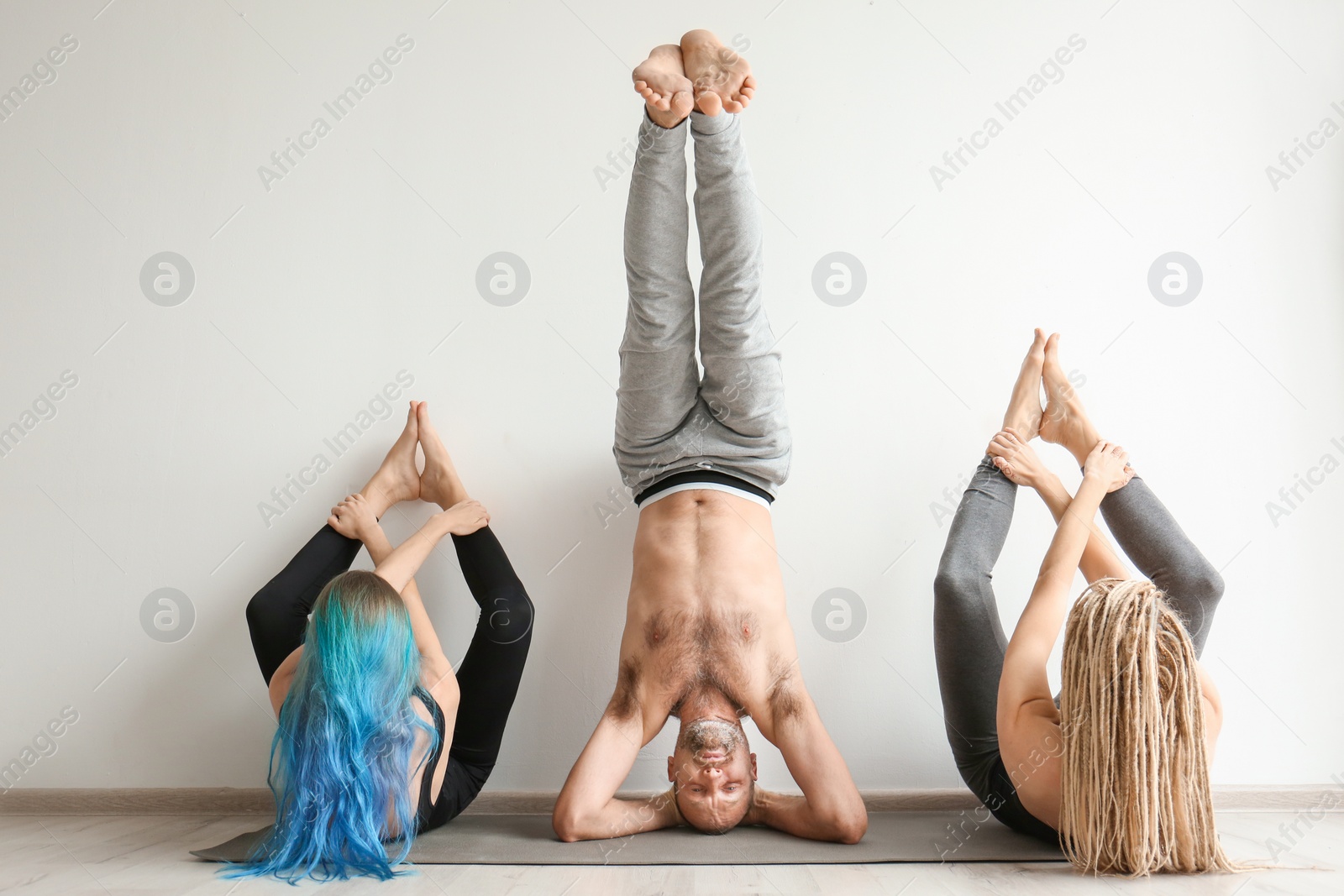 Photo of Group of people practicing yoga indoors