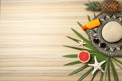 Photo of Flat lay composition with fruits and beach objects on wooden background. Space for text