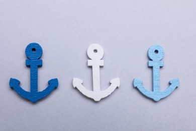 Anchor figures on light grey background, flat lay