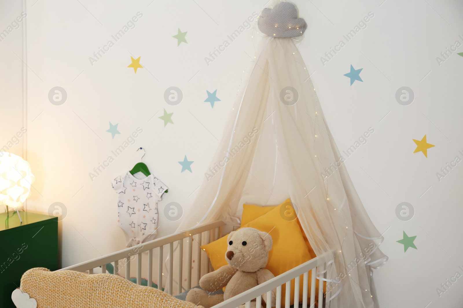 Photo of Stylish baby room interior with crib