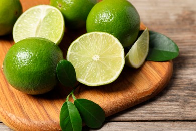 Fresh ripe limes on wooden table, closeup