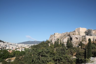 Photo of Picturesque view of cityscape with beautiful houses and acropolis on sunny day