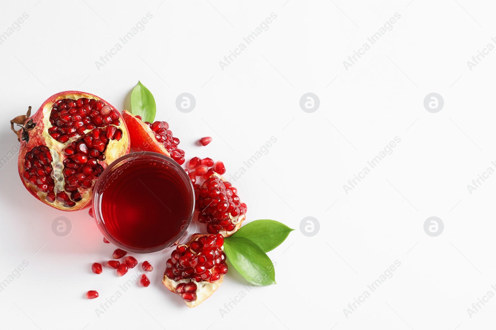 Photo of Glass of pomegranate juice and fresh fruits on white background, top view