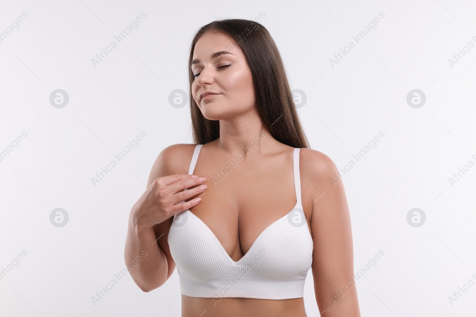 Photo of Portrait of young woman with beautiful breast on white background