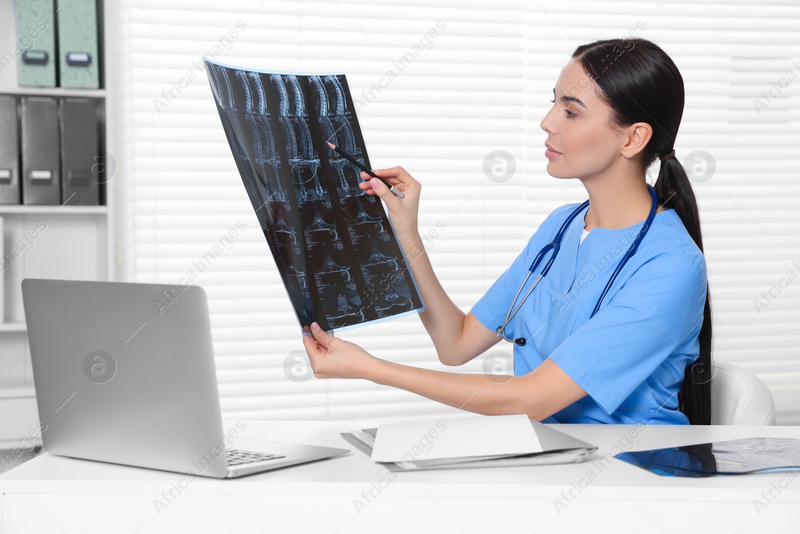 Photo of Doctor examining neck MRI image in clinic