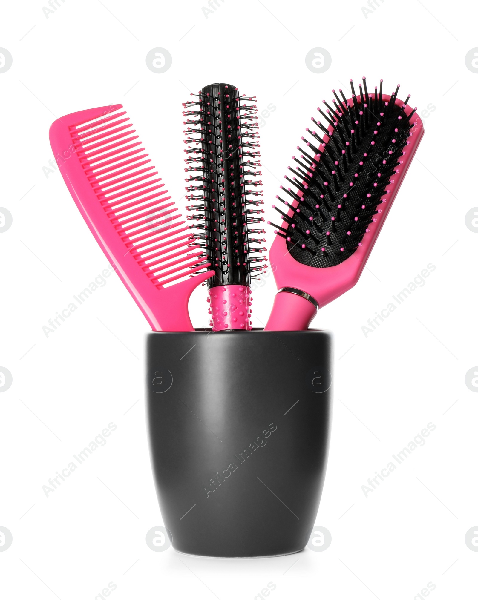 Photo of Hairbrushes and comb in holder on white background