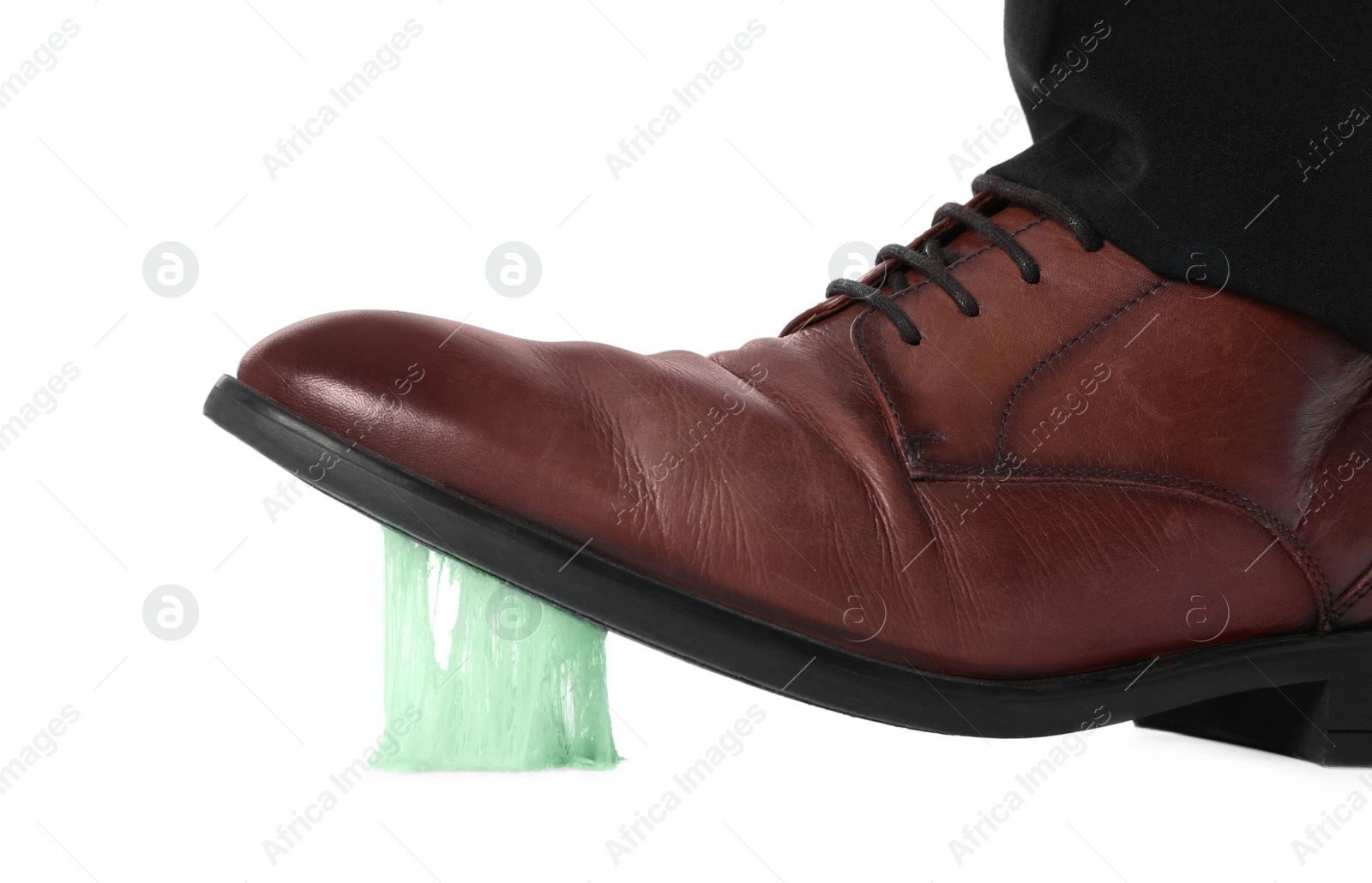 Photo of Man stepping into chewing gum on white background, closeup