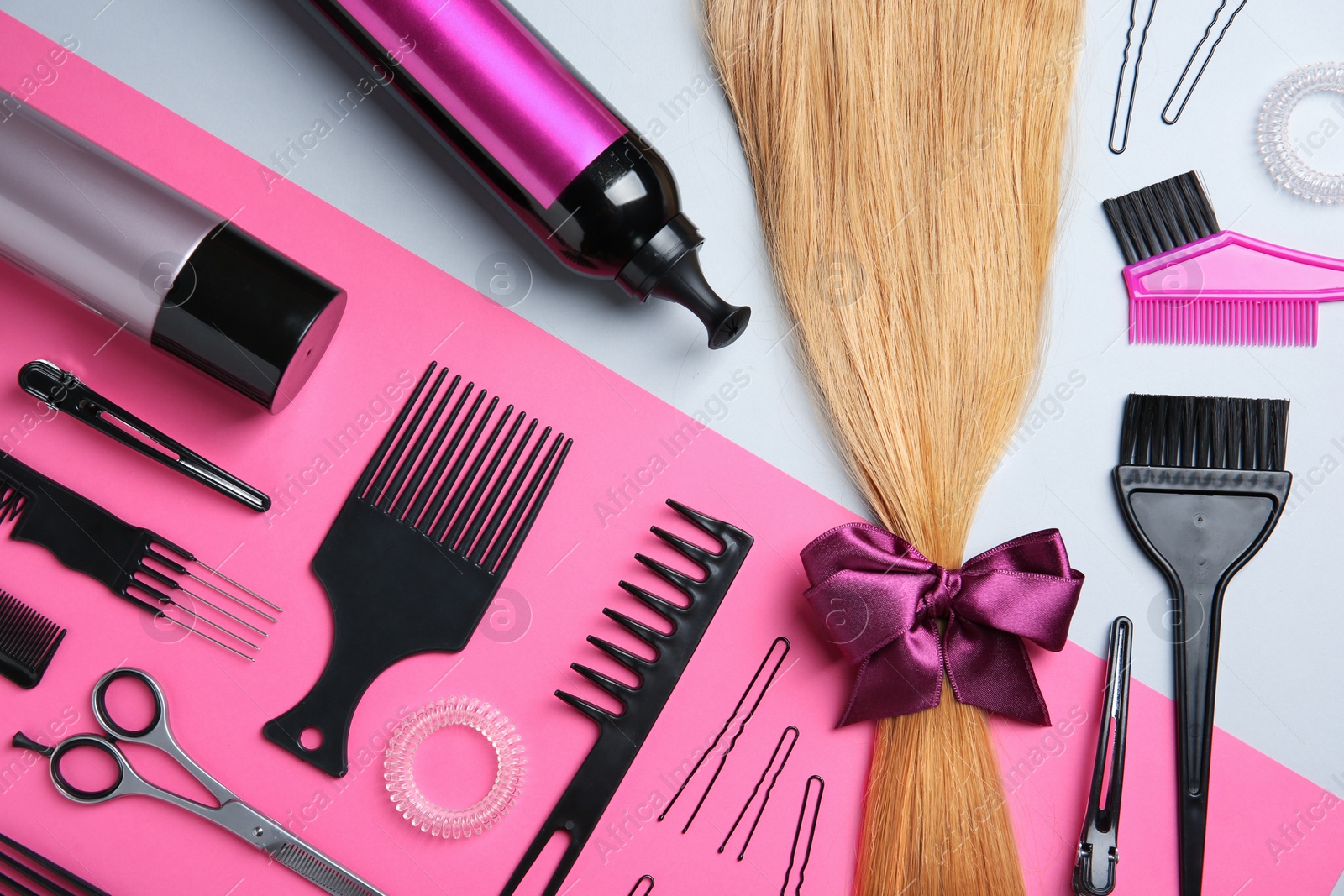 Photo of Flat lay composition with hair salon tools on color background