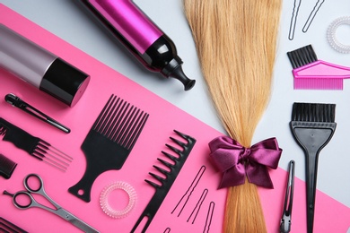 Photo of Flat lay composition with hair salon tools on color background