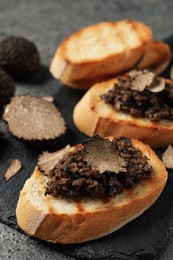 Photo of Delicious bruschettas with truffle sauce on grey table, closeup