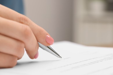 Photo of Woman signing document, closeup view. Space for text