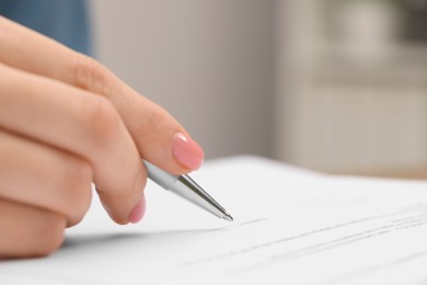 Woman signing document, closeup view. Space for text