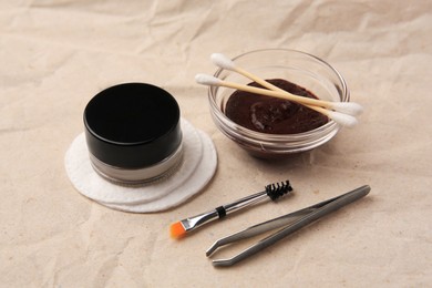 Photo of Eyebrow henna and tools on crumpled paper