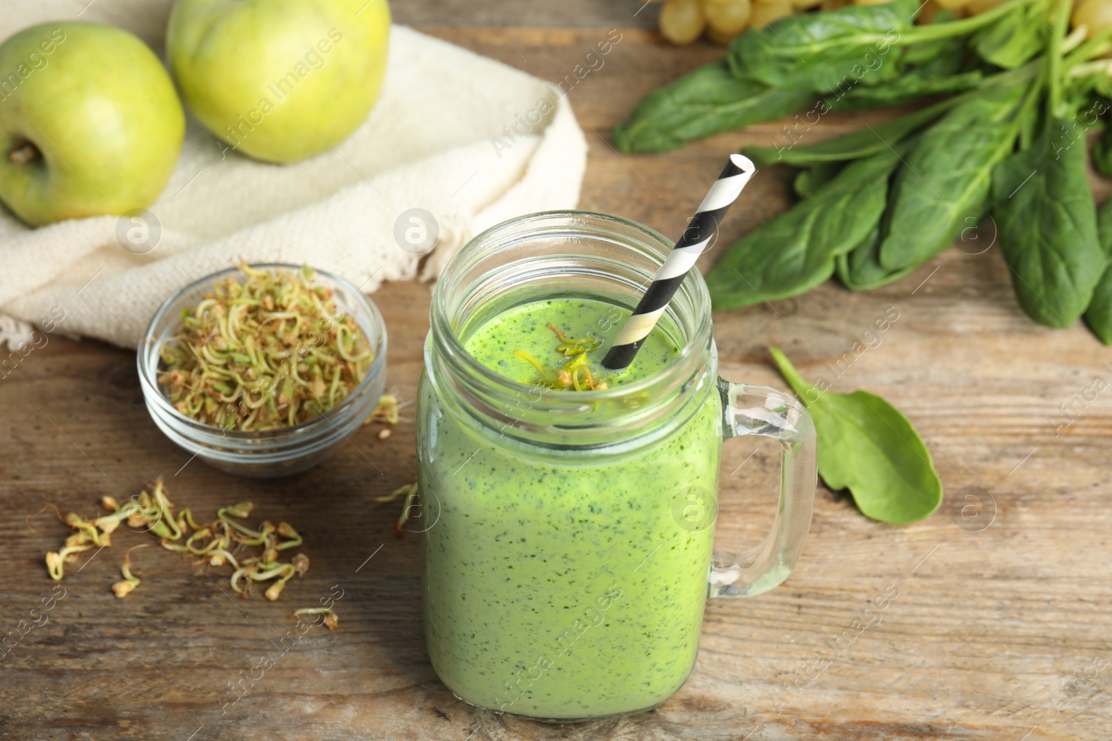 Photo of Tasty green buckwheat smoothie on wooden table