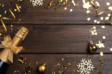 Photo of Frame of sparkling wine and festive decor on wooden background, flat lay with space for text. Happy New Year