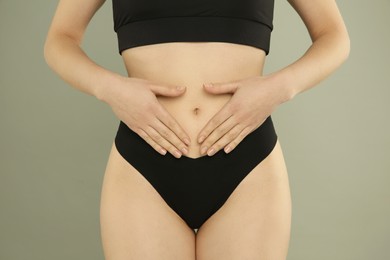 Photo of Gynecology. Woman in underwear on grey background, closeup