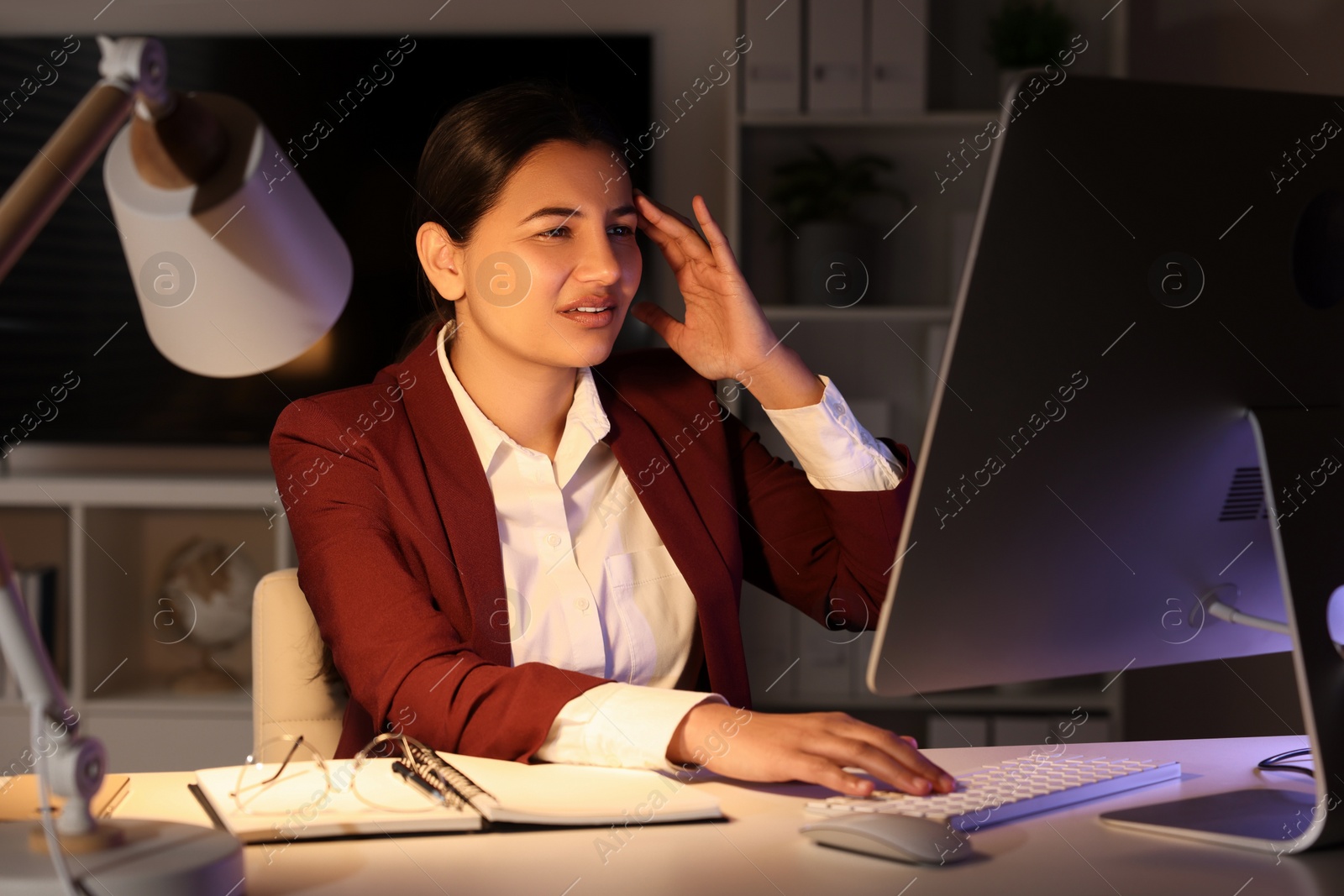 Photo of Tired businesswoman working at table in office