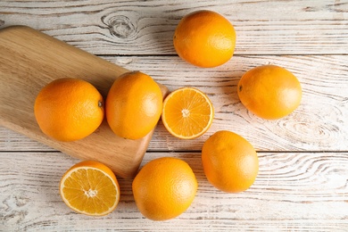 Flat lay composition with fresh oranges on wooden table